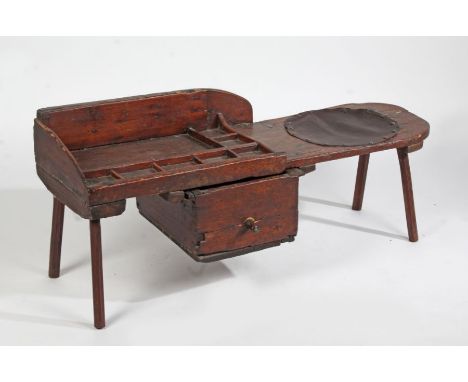 A 19th Century and later dark stained pine cobblers bench, with leather covered circular aperture to one end and compartmente