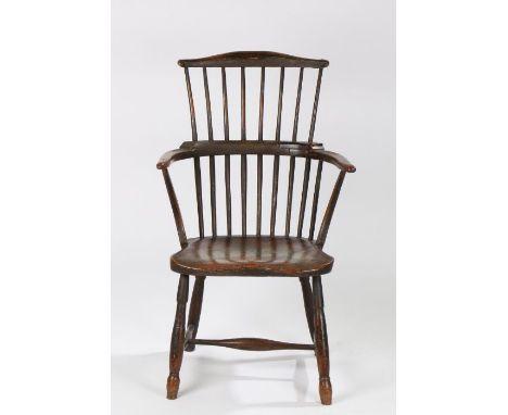 A George III stick back ash and elm painted Windsor armchair, West Country, circa 1800/1820, the arched top rail above a eigh