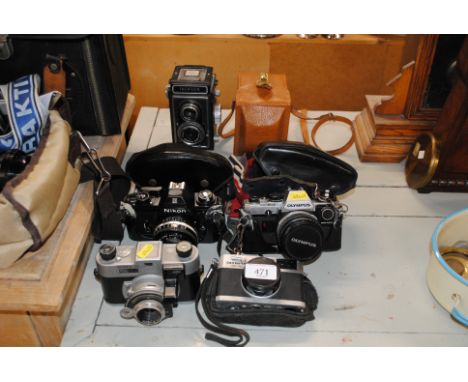 A Zeiss Ikon Ikoflex camera with leather carry case and a Nikon EM, a Kodak 35, an Olympus 35RC and an Olympus OM 10