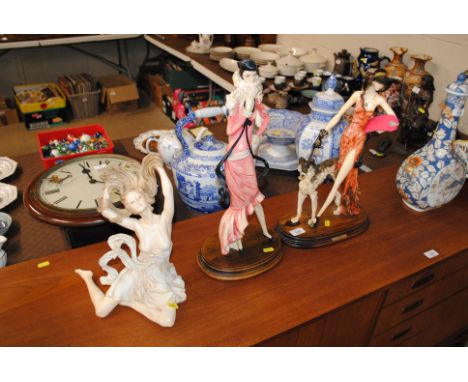 An Art Deco style figure of a lady walking her Russian Borzoi Hound together with another Art Deco style figure after M Santi