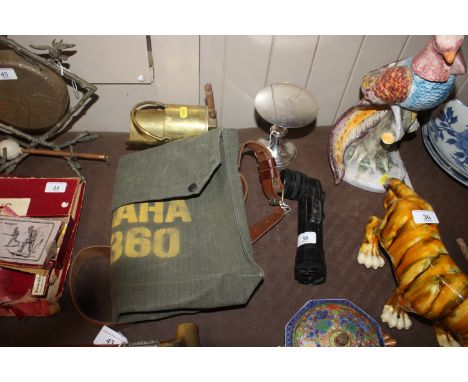 A military plated travelling Communion set; a Yamaha DT 360 Despatch bag; a Military flash light and a brass Trench Art minia