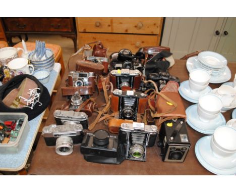 A large quantity of various cameras to include Brownie, Pentax, Kodak, etc.