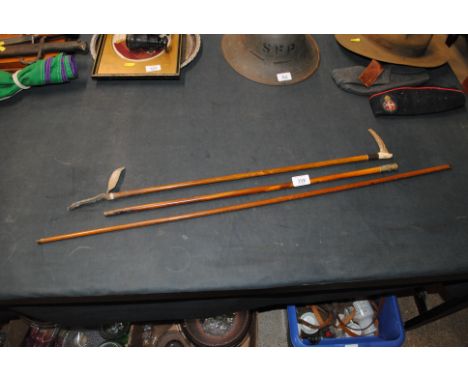 A Regimental swagger stick, a riding crop and a yard measuring stick