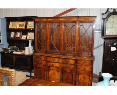 A reproduction mahogany break front bookcase fitted with a secretaire drawer