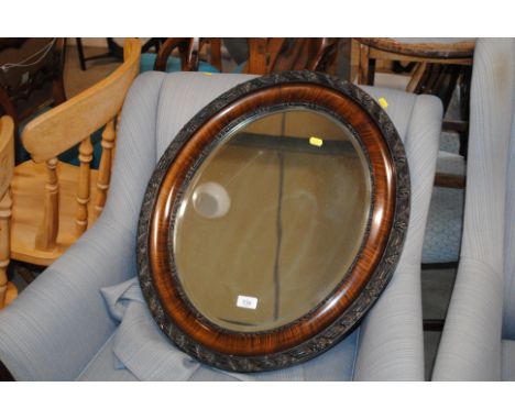 An oval bevel edge wall mirror