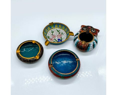 An assortment of brass and enamel ashtrays, each uniquely decorated with flowers. Three are circular and the fourth is shaped