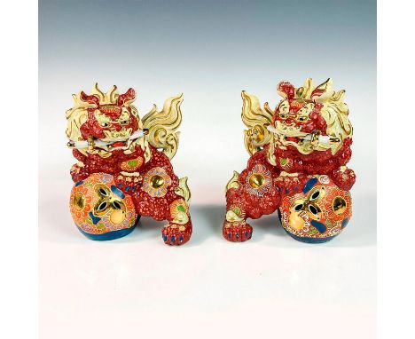 Vintage foo dogs resting on a floral balls and swords in their mouths, decorated in enamel and gold gilt. Kutani craved marki