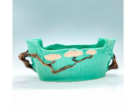 This vintage green ceramic bowl is a remarkable ceramic vessel that showcases the exquisite contrast between functionality an