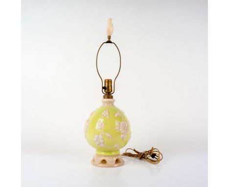 A Chartreuse green lamp with white embossed white flowers and leaf flourish finial. Aladdin embossed mark on the base. Issued