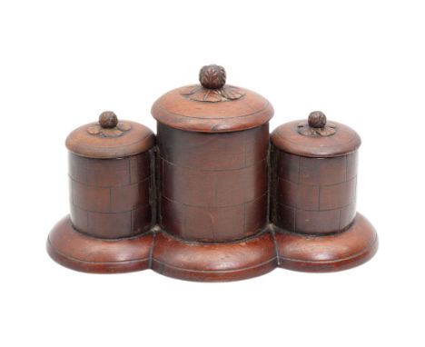 20th century three part smokers caddy, the lids with floral finials, upon a stepped wooden base, H14cm