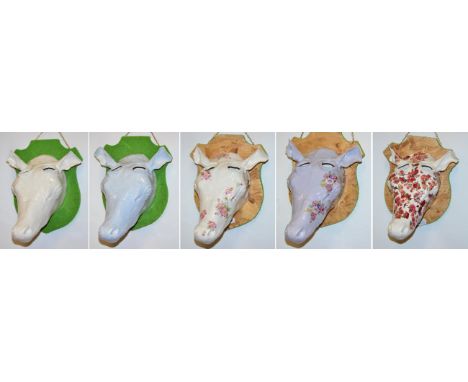 British School (Contemporary) Floral cow head Ceramic mounted on a wooden plaque, together with four further different exampl