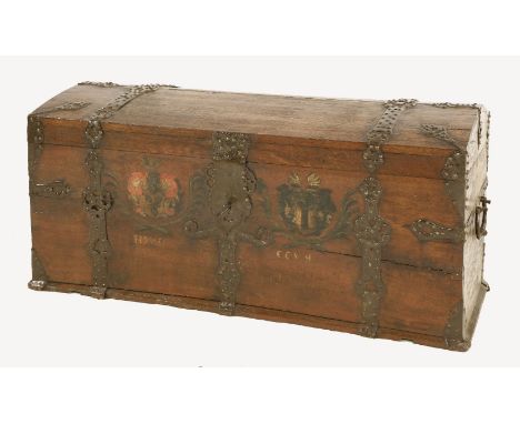 A Continental oak dome top trunk,19th century, with bold iron straps and banding and painted coats of arms to the front, with