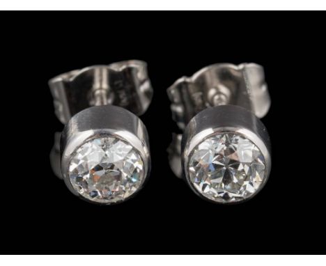 A pair of platinum and diamond single-stone ear-studs: each with a round old, brilliant-cut diamond approximately 5.5mm diame