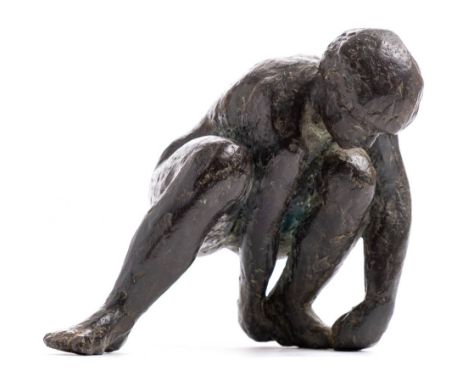 After Karel Vogel, a bronze figure of a crouching man: attending to his left foot, unsigned , 17cm. long.