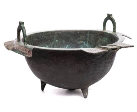 An Islamic white metal inlaid bronze cooking pot.: of conical tapering form, with flanged lugs and loop handles, 48cm diamete