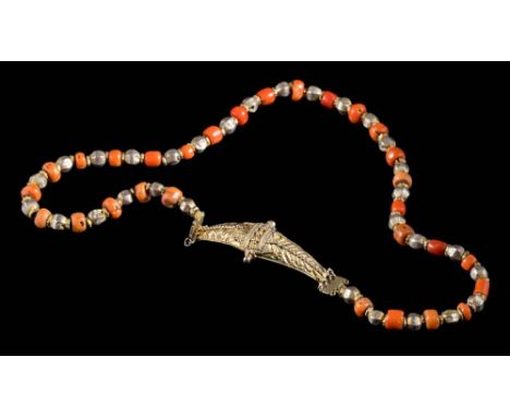 An Indo-Persian coral and silver gilt necklace: on silver gilt clasp with applied beaded decoration, approximately 51cm long 