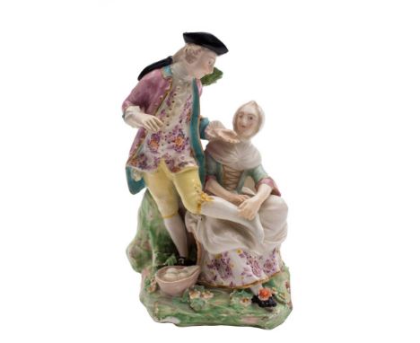 A Derby group the 'Stocking Mender': the gallant wearing a pink jacket and floral waistcoat, the seated girl attending to his