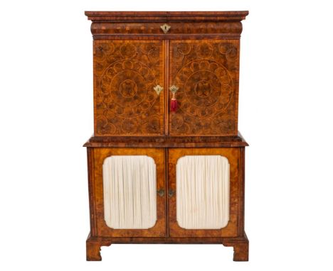 An early 18th Century reconstructed oyster and burr veneered walnut inlaid cabinet: in two sections, the upper part with a mo