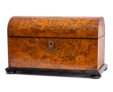 A Victorian burr walnut and brass inlaid tea caddy: of rectangular outline, the domed hinged lid enclosing a central glass bl