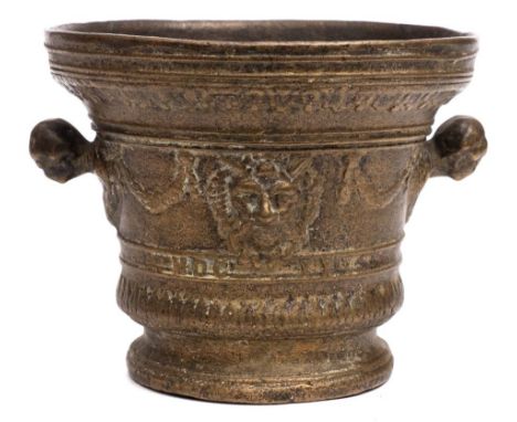 A bronze mortar in the 17th century taste: with garland and satyr mask banded decoration, with figurehead handles to the side
