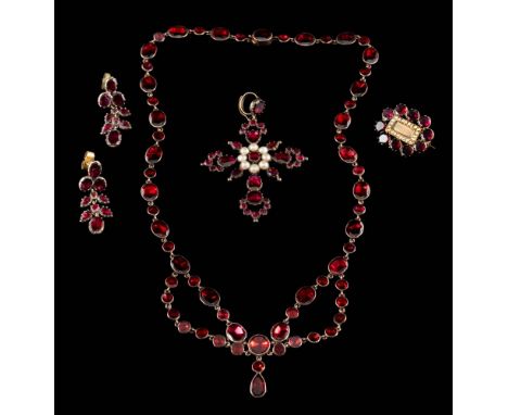 A Georgian flat garnet necklace: with oval and circular garnets in closed back settings and suspending a pear-shaped drop, to