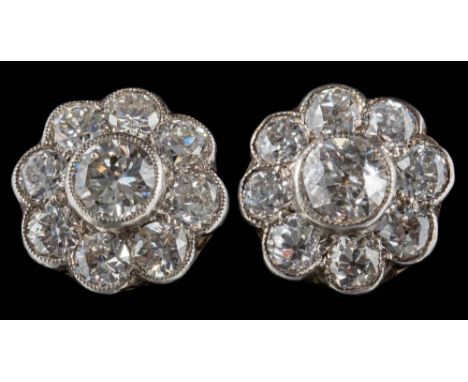 A pair of diamond mounted circular cluster ear-studs: 9.7mm diameter with round old brilliant-cut diamonds estimated to weigh