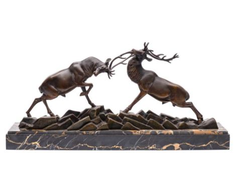 After Irenee Rochard (1906-1984) A bronze study of rutting stags on a rocky plinth,: mounted on a rectangular polished marble