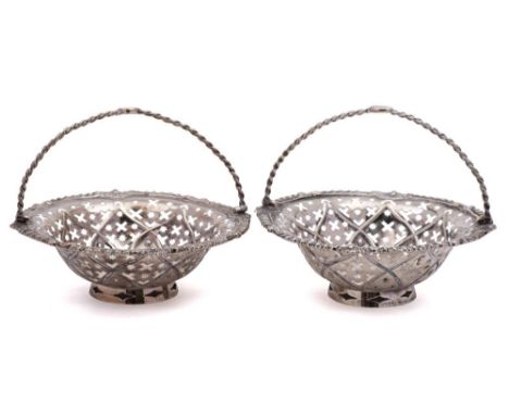 A pair of silver swing-handled sweetmeat baskets,maker W.H possibly William Holmes:, of circular outline with spiral twist lo