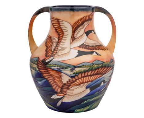 A limited edition Moorcroft pottery two handled vase: tubelined after a design by Philip Gibson with Canada Geese in flight o