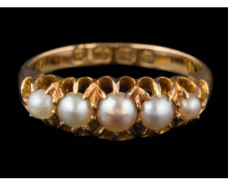 An 18ct gold and seed pearl mounted five-stone ring: in claw setting, Birmingham assay marks to shank, ring size K. 