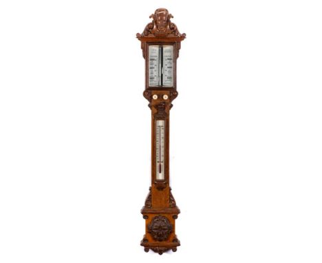 A carved oak stick barometer: having two bone dials set aslant for 10 A.M. Yesterday and 10 A.M. Today, with the instruction 