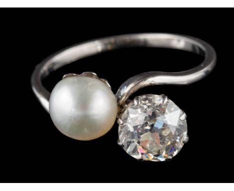 A pearl and diamond two-stone cross-over ring: the round old, brilliant-cut diamond approximately 6.2mm diameter x 4.2mm deep