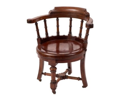 A Victorian mahogany captain's chair:, the back with horseshoe shaped top rail and ring turned uprights, having a circular so