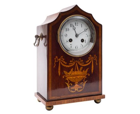 An Edwardian French mantel clock: the eight-day duration movement striking the hours and half-hours on a gong, the backplate 