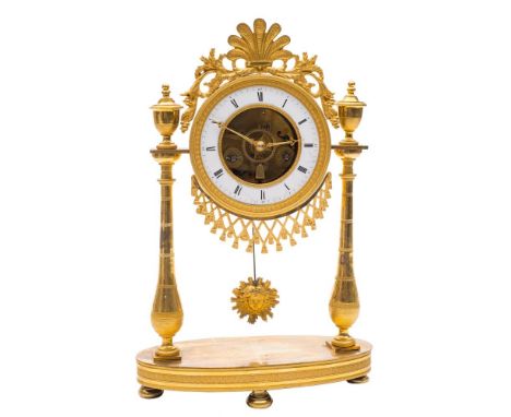 A Continental ormolu portico clock: the eight-day duration movement having a silk-suspension and striking the hours and half-