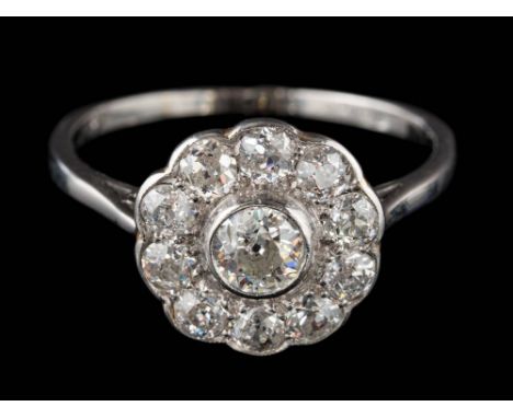 A 20th Century diamond circular cluster ring: mille-grain-set with round old, brilliant-cut diamonds estimated to weigh a tot