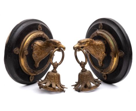 A pair of late 19th century gilt brass wall light fittings:  in the form of eagle heads with acanthus decorated fitment hung 