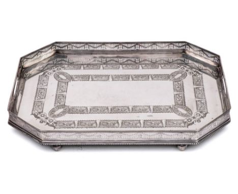 A silver plated rectangular galleried tray: with canted corners, with foliate and scroll banded decoration, raised on four ba