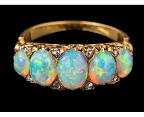 A graduated opal five-stone ring: the oval opals graduate from approximately 5mm long to 7.4mm long, between diamond points a