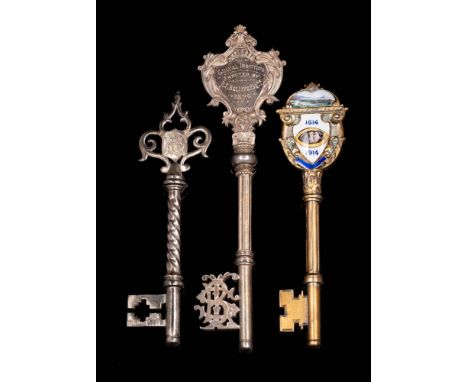 A George V silver gilt and enamel presentation key, maker Vaughton &amp; Sons, Birmingham, 1911: inscribed, 12.5cm. long, tog