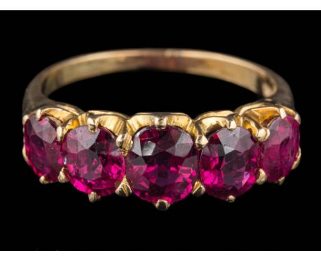 A graduated ruby five-stone ring: the oval rubies graduate from approximately 5mm long to 6mm long, the shank stamped '18ct',