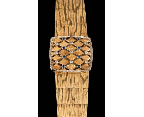 Longines. A lady's 18ct gold, sapphire and diamond wristwatch: the circular dial with baton markers and concealed by a sapphi