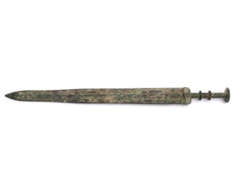 A Chinese bronze sword (Jian): having a 44cm. double-edged blade, with double knopped cylindrical grip and flattened pommel, 