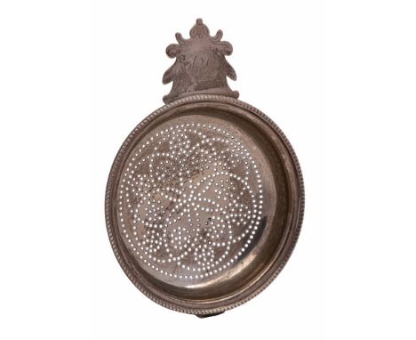 A George IV silver lemon strainer, no maker's mark, London, 1822: initialled, with beaded border, perforated bowl and arched 