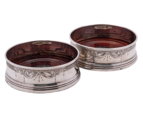 A pair of Elizabeth II silver bottle coasters, maker W Broadway &amp; Co, Birmingham, 1994: of circular form with engraved sc