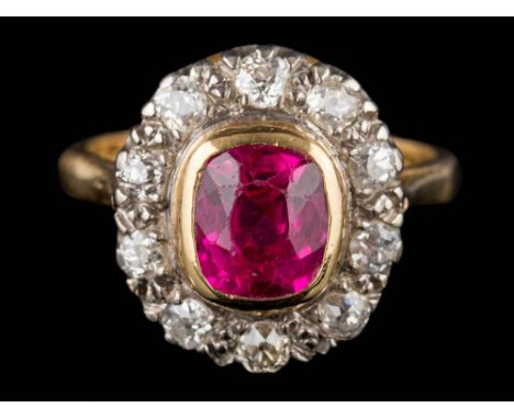 A synthetic ruby and diamond cushion-shaped cluster ring: the cushion-shaped synthetic ruby approximately 8mm long x 7.5mm wi