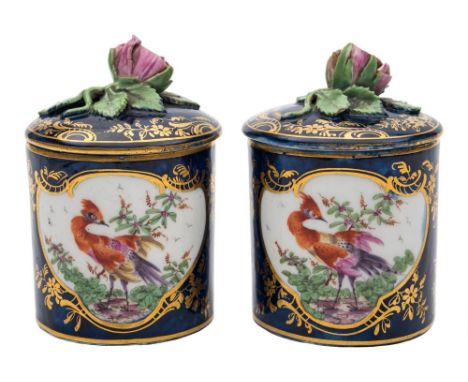 A pair of Derby toilet/pomade pots and covers: of cylindrical form with bud finials, each painted with exotic birds within gi