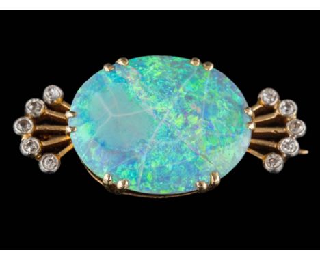 An opal and diamond brooch: the central, oval opal approximately 19mm long x 15mm wide x 3mm deep, claw-set between fan shape