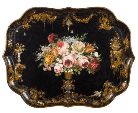 A large 19th century papier mache tray: of cartouche-shaped outline, the centre decorated with a vase and floral spray, enclo