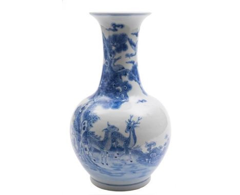 A Chinese blue and white bottle vase: painted with deer in a landscape with a large pine tree, lingzhi, fungus and rockwork, 